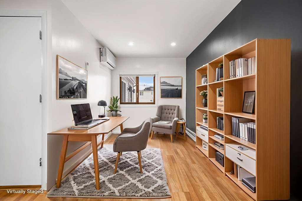 34 Paris Street Everett, MA 02149 - Photo 11 of 25 a workspace with furniture bookshelf and a workspace