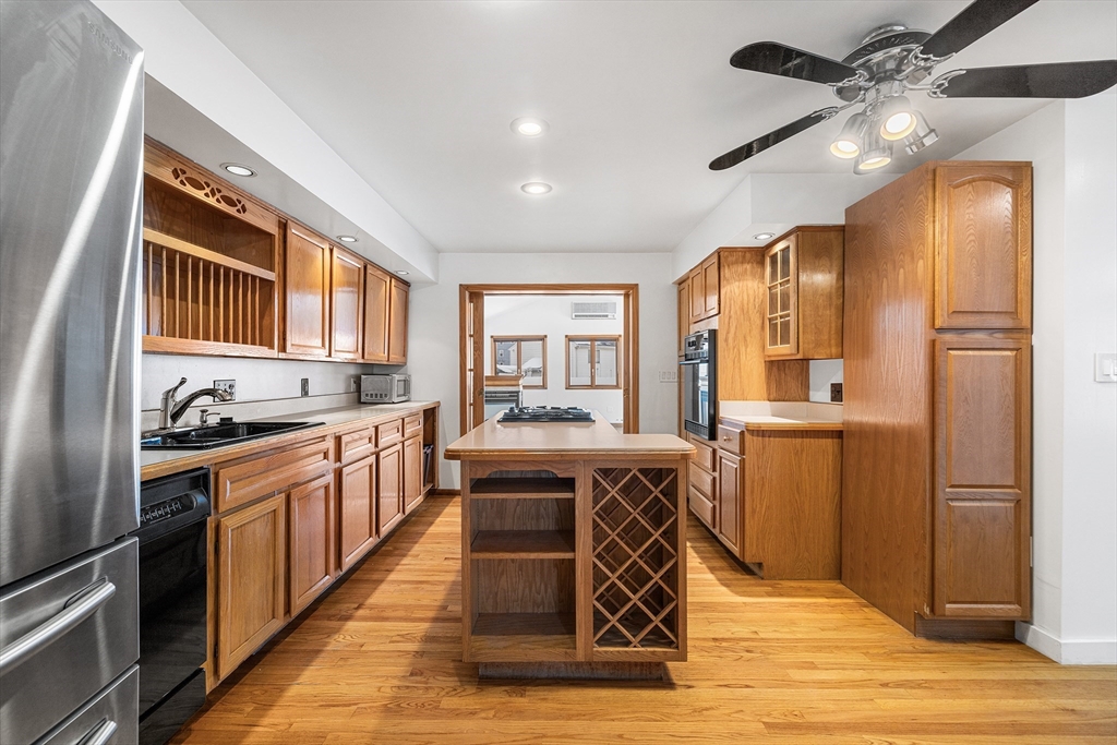 34 Paris Street Everett, MA 02149 - Photo 3 of 25 a kitchen with stainless steel appliances granite countertop a sink a stove a refrigerator cabinets and dining table