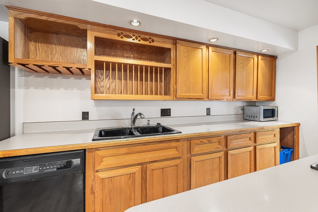 34 Paris Street Everett, MA 02149 - Photo 5 of 25 a kitchen with stainless steel appliances granite countertop a sink and cabinets