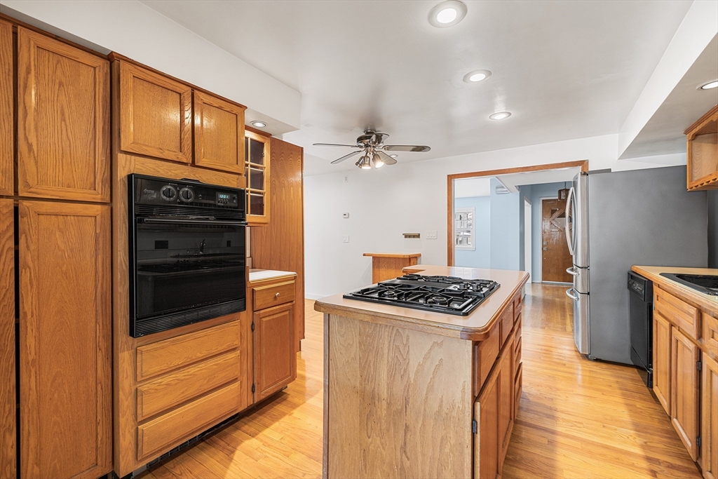 34 Paris Street Everett, MA 02149 - Photo 6 of 25 a kitchen with granite countertop stainless steel appliances and wooden cabinets