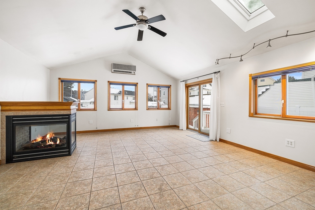 34 Paris Street Everett, MA 02149 - Photo 8 of 25 a view of an empty room with a fireplace and a window