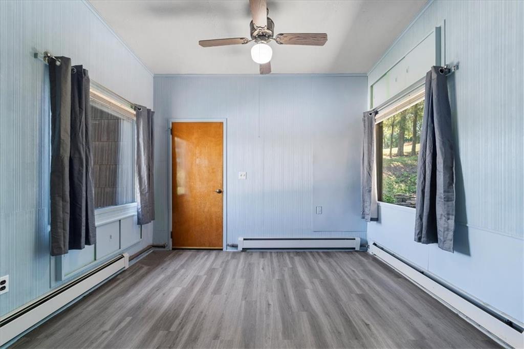 1143 Altman Road Jeannette, PA 15644 - Photo 20 of 50 an empty room with wooden floor cabinet and windows