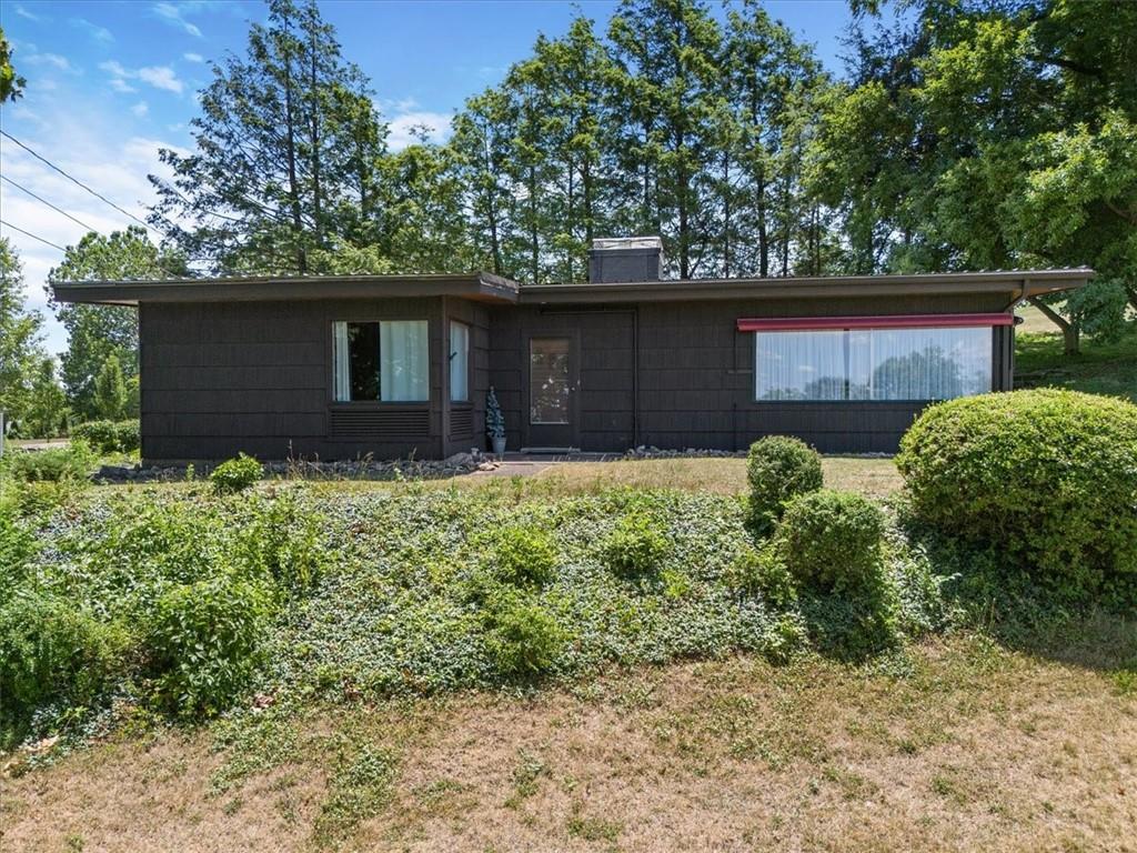 1143 Altman Road Jeannette, PA 15644 - Photo 2 of 50 a front view of house with yard and trees
