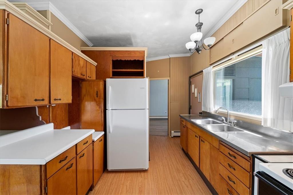 1143 Altman Road Jeannette, PA 15644 - Photo 23 of 50 a kitchen with sink a refrigerator and wooden floor
