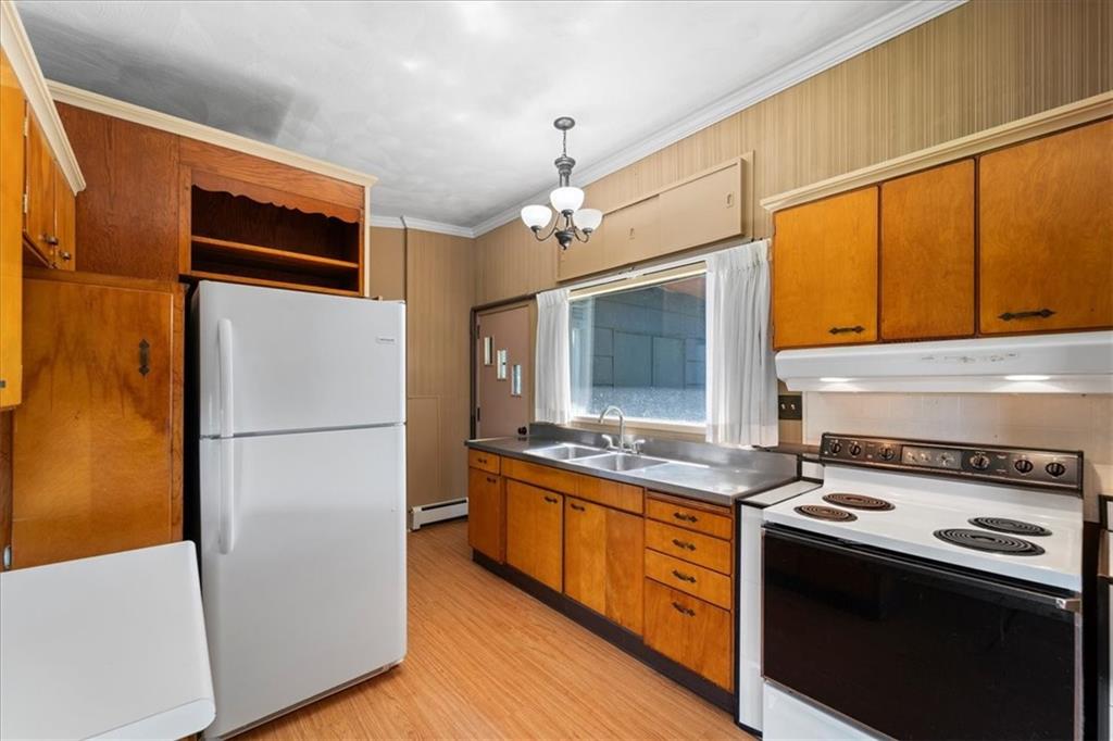 1143 Altman Road Jeannette, PA 15644 - Photo 24 of 50 a kitchen with stainless steel appliances a refrigerator a stove a sink and a microwave