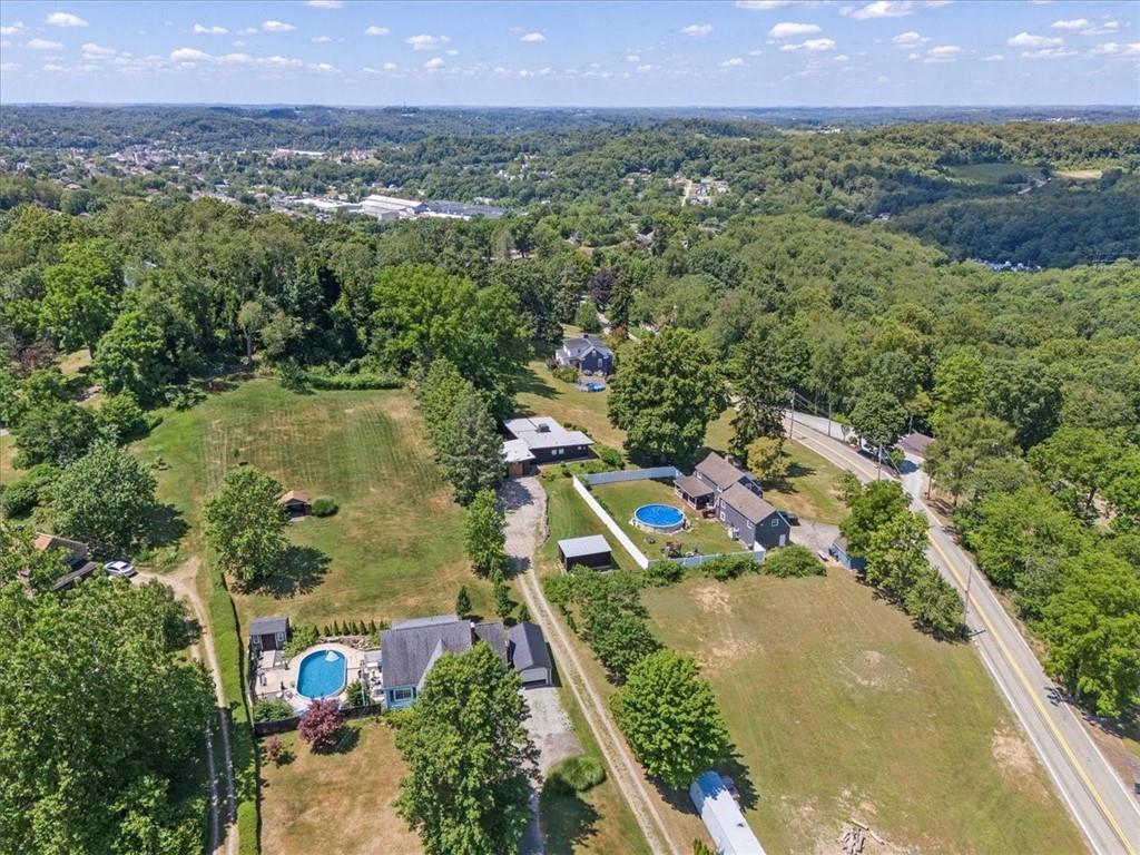 1143 Altman Road Jeannette, PA 15644 - Photo 42 of 50 an aerial view of a residential houses covered in trees and lake