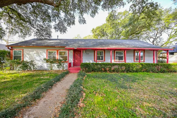 a front view of a house with a yard and outdoor seating