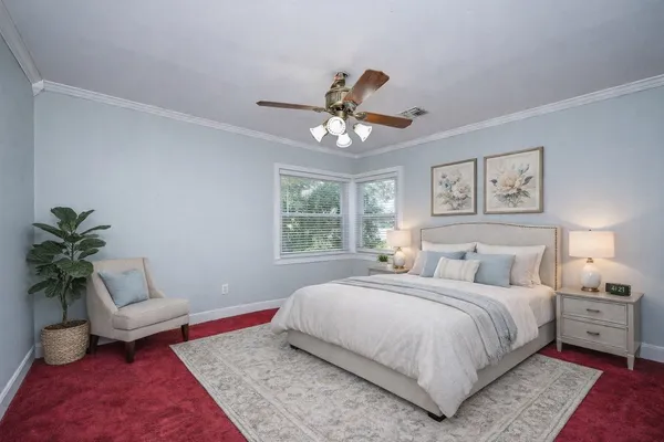a bedroom with a large bed and a couch