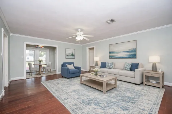 a living room with furniture and wooden floor