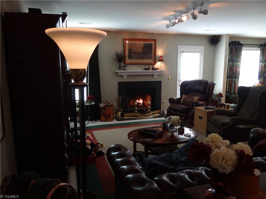 2207 Acorn Ridge Road Greensboro, NC 27407 - Photo 7 of 18 Spacious living room with wood burning fireplace and track lighting