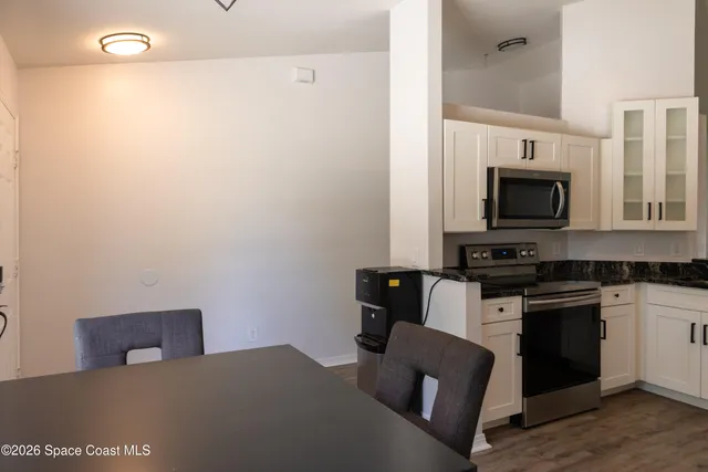 a kitchen with stainless steel appliances a stove top oven a sink and a microwave