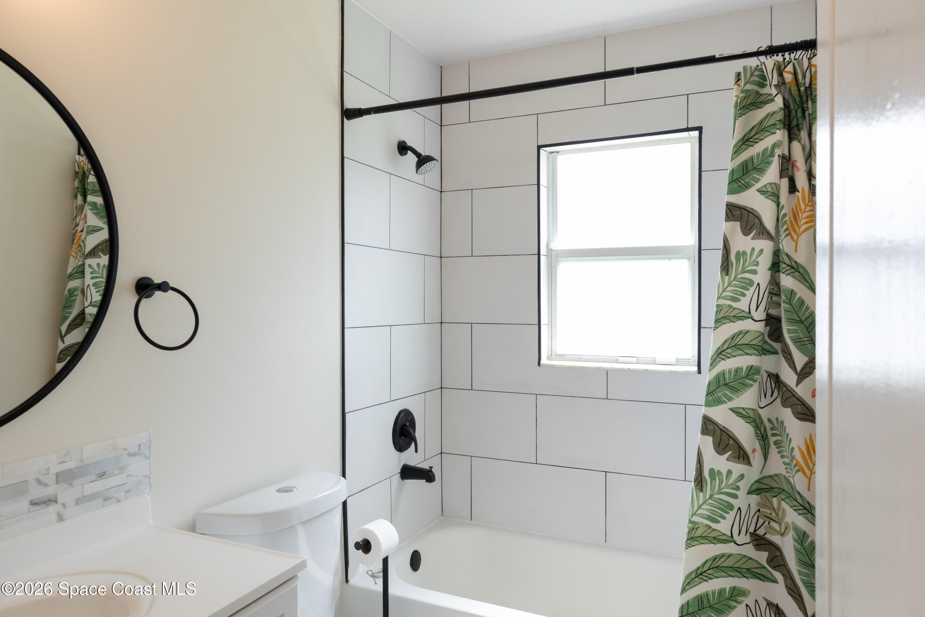 1572 Holbrook Road Northwest Palm Bay, FL 32907 - Photo 17 of 38 a bathroom with a bathtub and shower