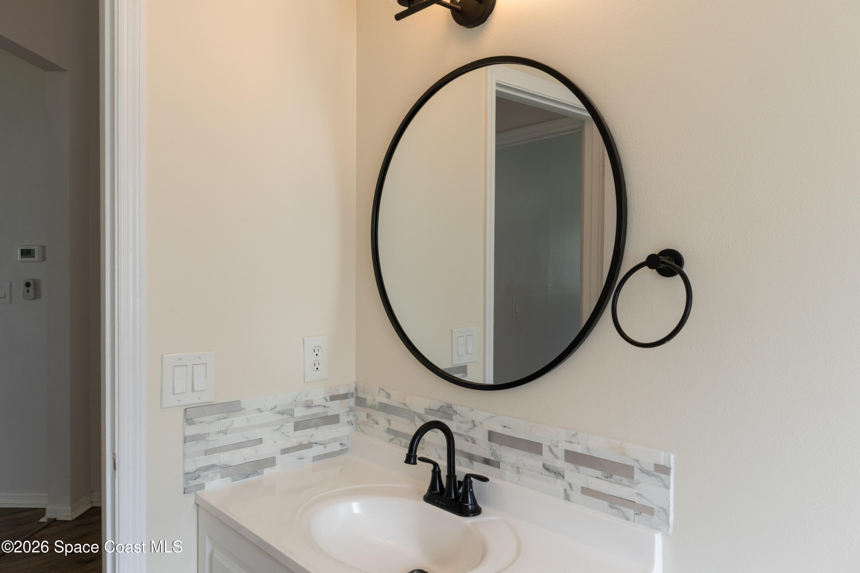 1572 Holbrook Road Northwest Palm Bay, FL 32907 - Photo 18 of 38 a bathroom with a sink and a mirror