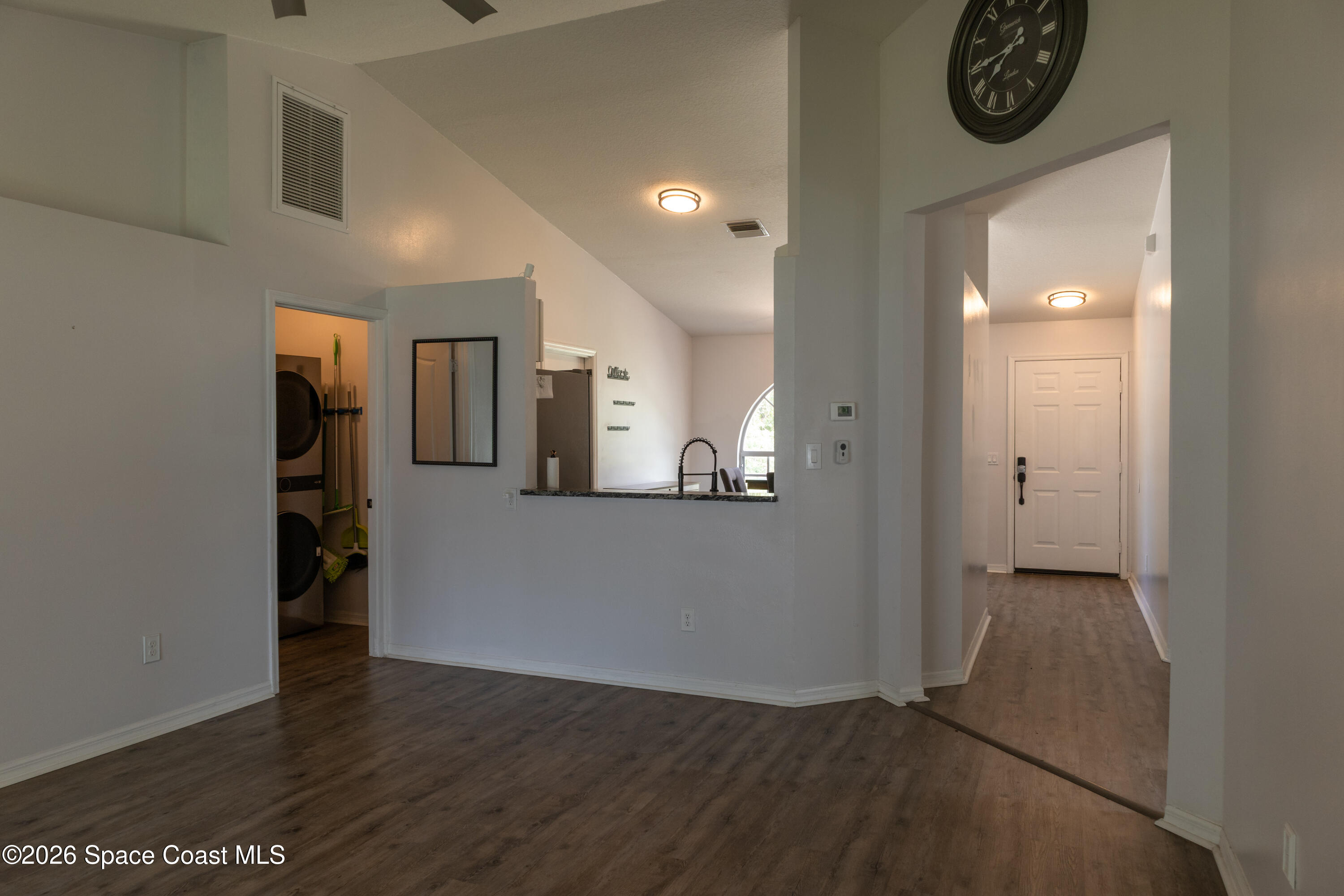 1572 Holbrook Road Northwest Palm Bay, FL 32907 - Photo 23 of 38 a view of a hallway with wooden floor and a bathroom