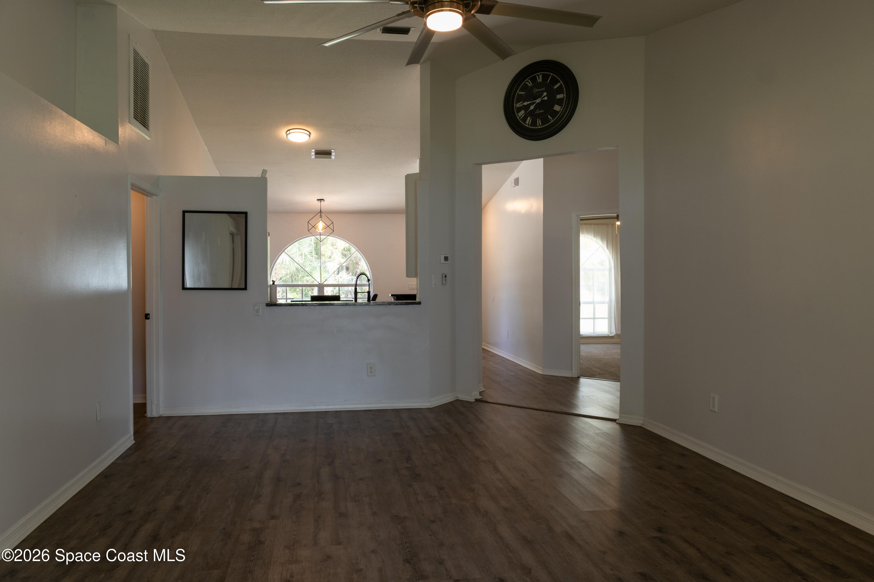 1572 Holbrook Road Northwest Palm Bay, FL 32907 - Photo 26 of 38 an empty room with wooden floor and windows