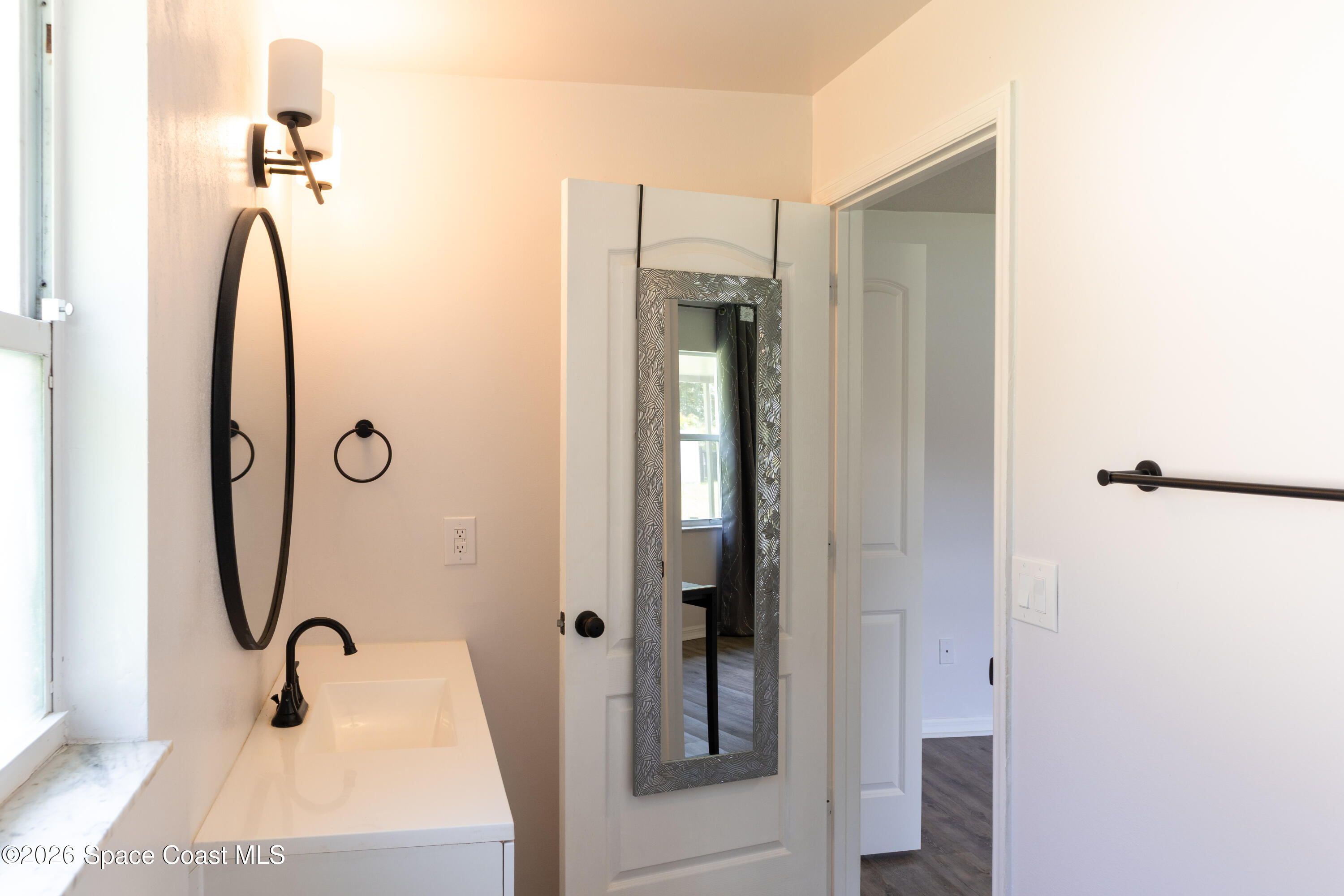 1572 Holbrook Road Northwest Palm Bay, FL 32907 - Photo 33 of 38 a bathroom with a shower and a sink