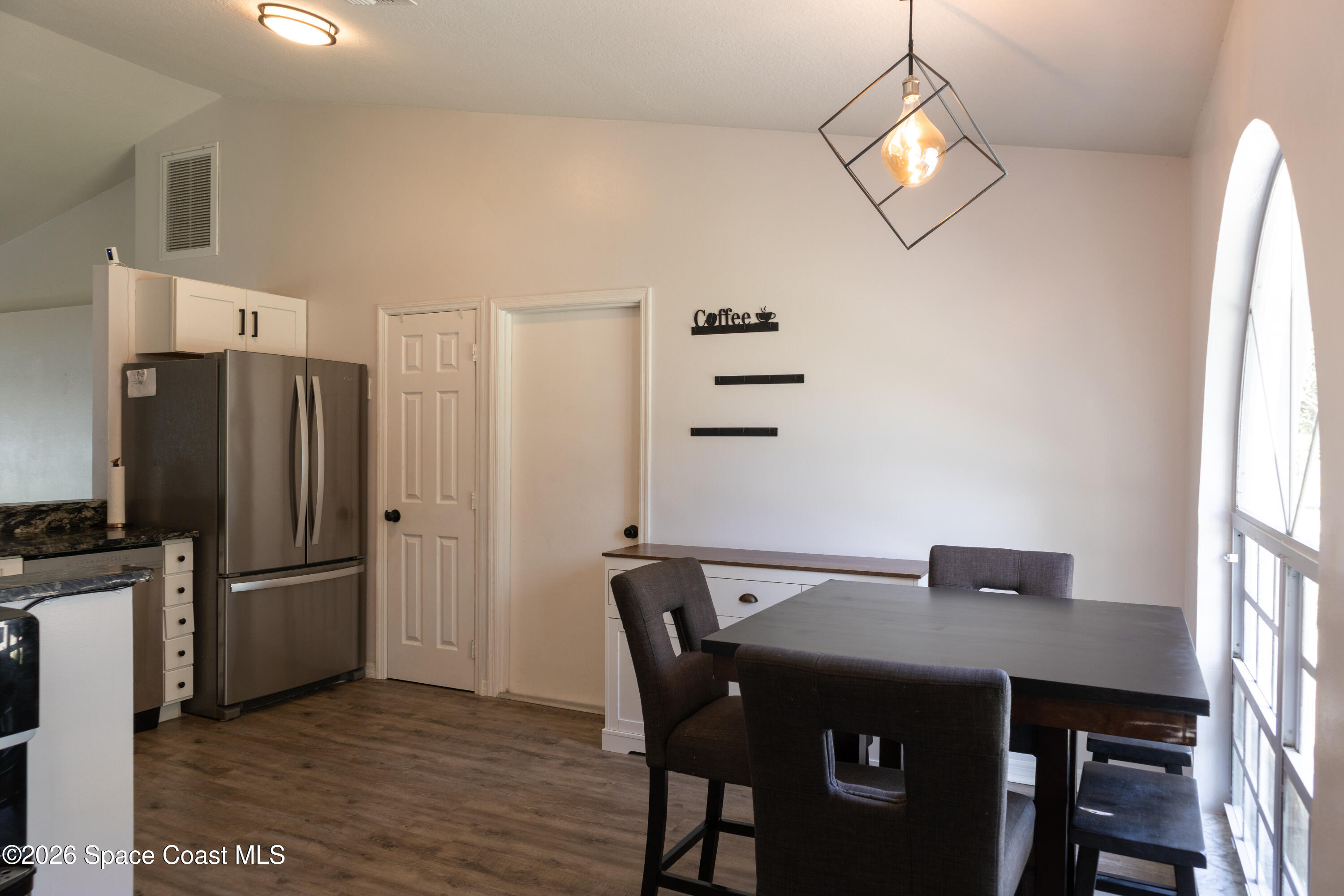 1572 Holbrook Road Northwest Palm Bay, FL 32907 - Photo 7 of 38 a view of a dining room with furniture and wooden floor