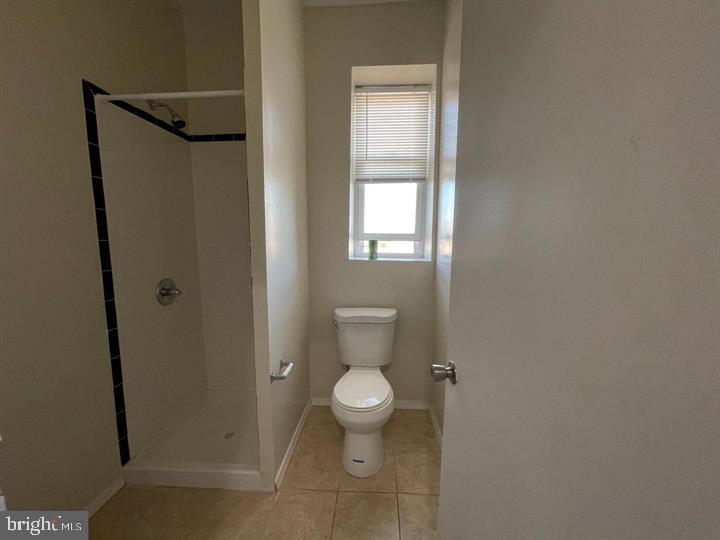 4726 Chestnut Street, Unit 8 Philadelphia, PA 19139 - Photo 8 of 9 a bathroom with a toilet and a shower