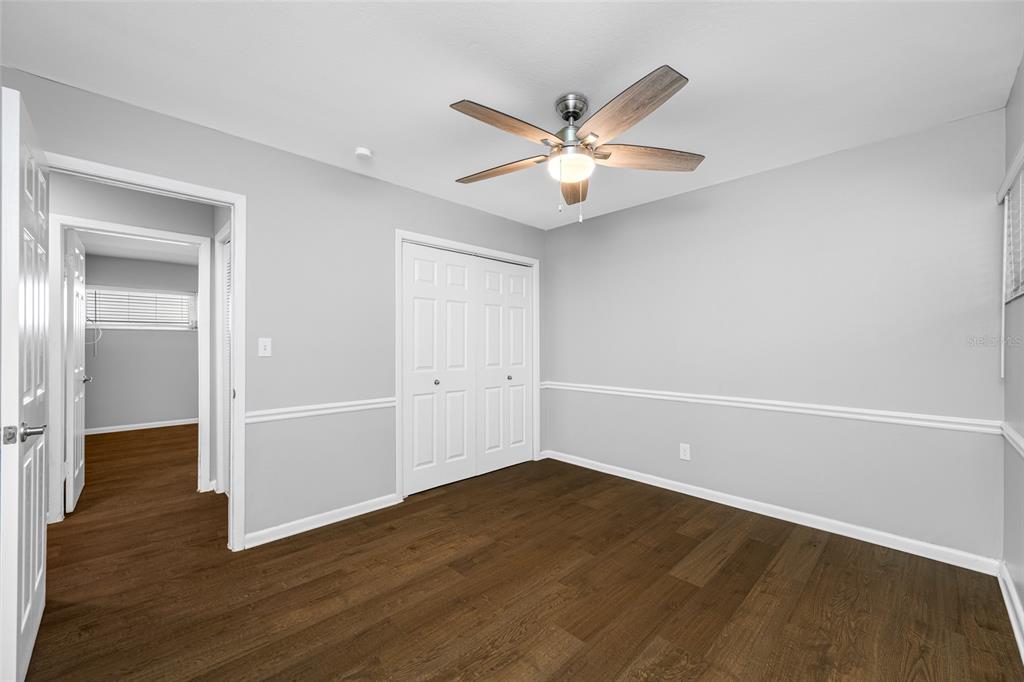 3602 South MacDill Avenue, Unit 1 Tampa, FL 33629 - Photo 13 of 18 an empty room with wooden floor and fan