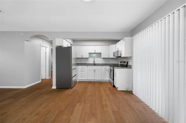 a kitchen with stainless steel appliances a refrigerator and a stove top oven