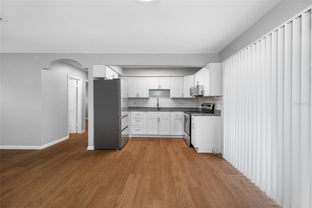 3602 South MacDill Avenue, Unit 1 Tampa, FL 33629 - Photo 4 of 18 a kitchen with stainless steel appliances a refrigerator and a stove top oven