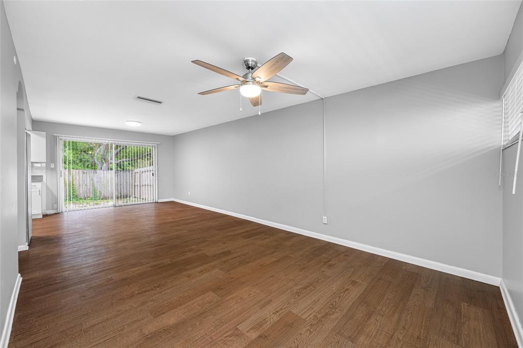 3602 South MacDill Avenue, Unit 1 Tampa, FL 33629 - Photo 5 of 18 an empty room with wooden floor and windows