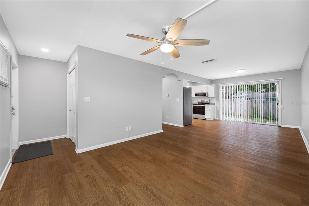 3602 South MacDill Avenue, Unit 1 Tampa, FL 33629 - Photo 6 of 18 a view of empty room with wooden floor and fan