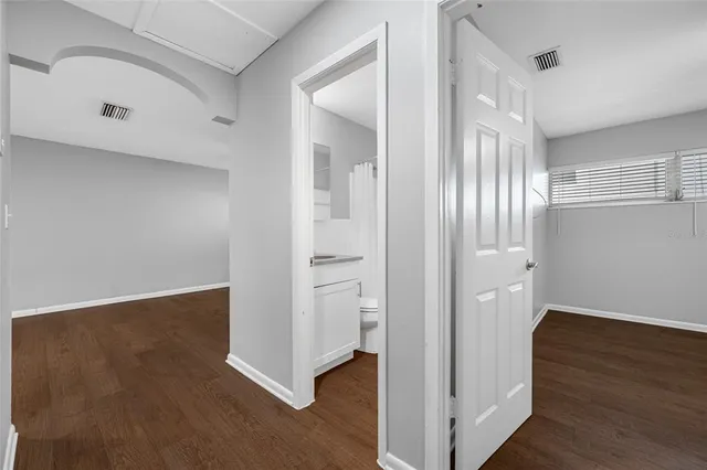 a view of a hallway with wooden floor