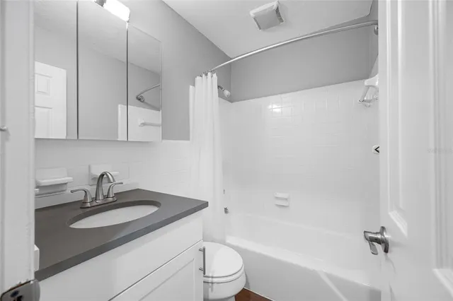 a bathroom with a sink a toilet and a bathtub