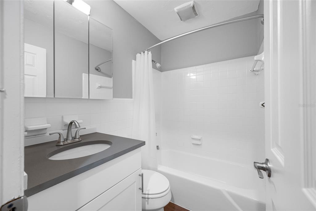 3602 South MacDill Avenue, Unit 1 Tampa, FL 33629 - Photo 8 of 18 a bathroom with a sink a toilet and a bathtub