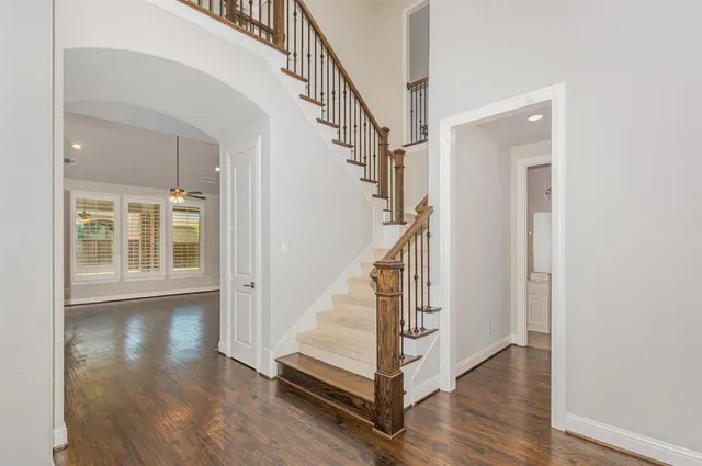 a view of staircase with white walls and a window