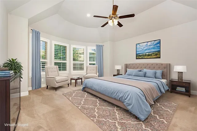 a spacious bedroom with a large bed and a window