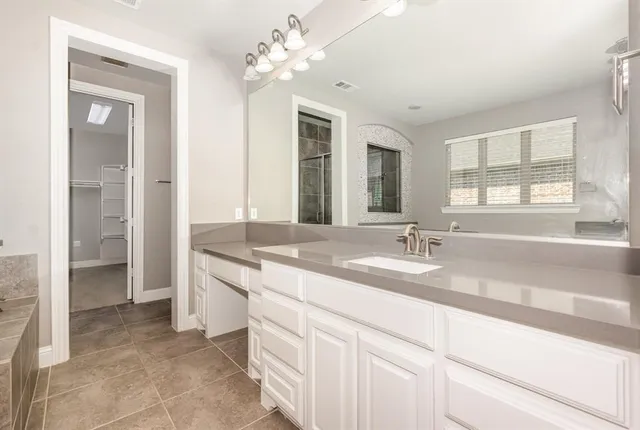 a bathroom with a sink and cabinets