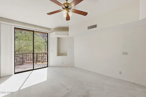 a view of a livingroom with a ceiling fan and window