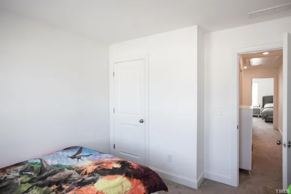a bed sitting in a bedroom next to a window