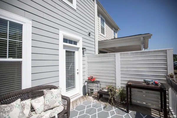 a view of deck with two chairs and wooden fence