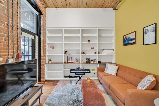 a living room with furniture a rug and a window