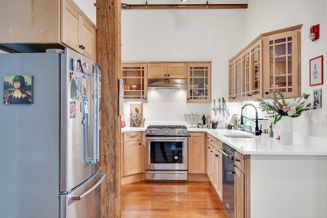 a kitchen with stainless steel appliances granite countertop a stove and a refrigerator