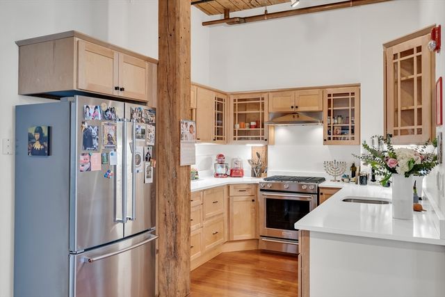 a kitchen with stainless steel appliances a refrigerator and a stove
