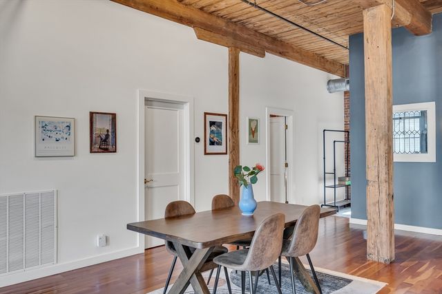 a view of a dining room with furniture and wooden floor