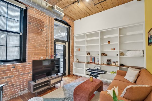 a bedroom with furniture and a flat screen tv