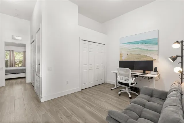 a view of a livingroom with workspace and a couch