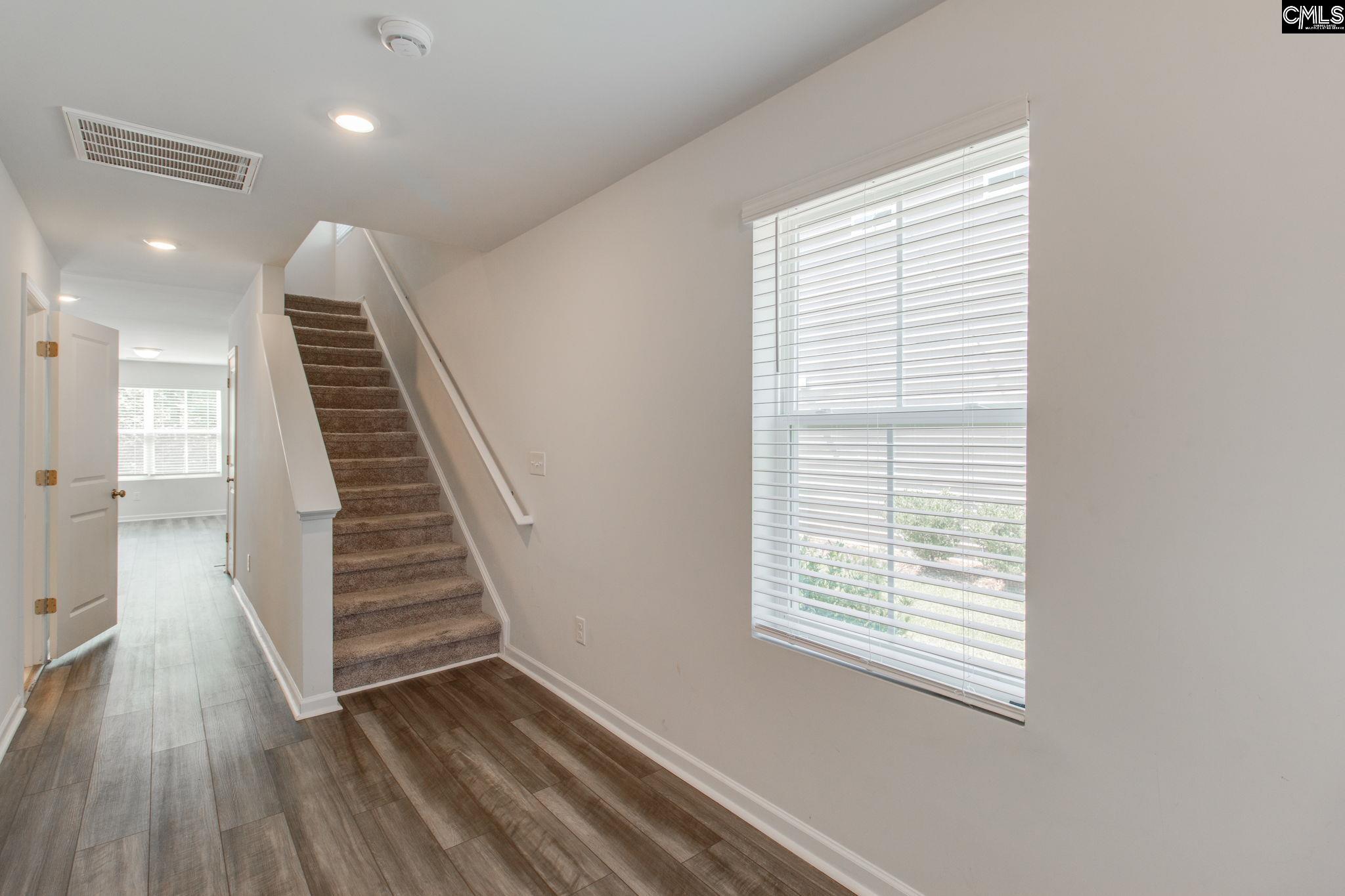 312 Reedmace Court Lexington, SC 29072 - Photo 4 of 29 a view of hallway with stairs and wooden floor