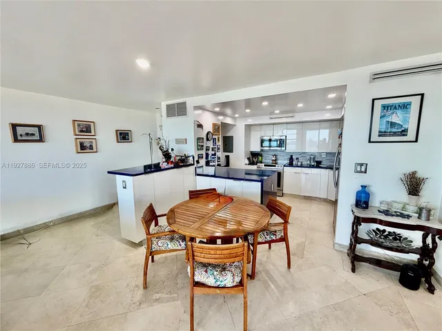 a living room with furniture and a dining table with wooden floor