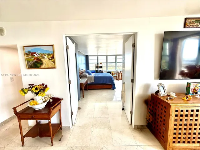 a bedroom with furniture and a window