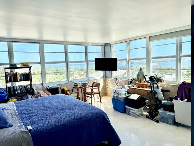 a bed room with a bed and a television