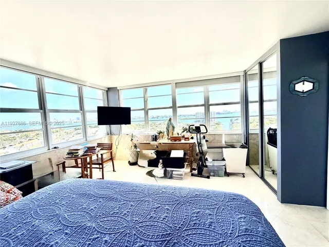 a living room with furniture large window and a table