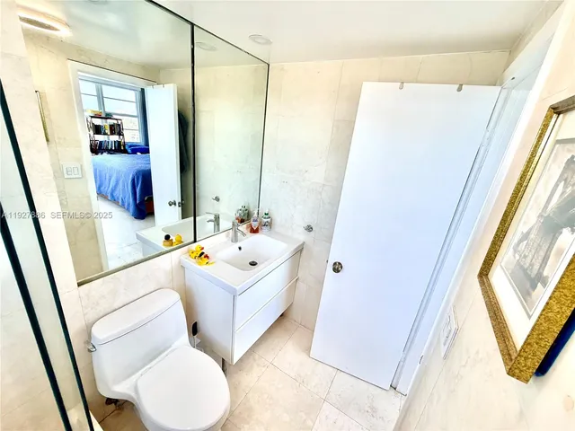 a bathroom with a sink a toilet a mirror and a tub
