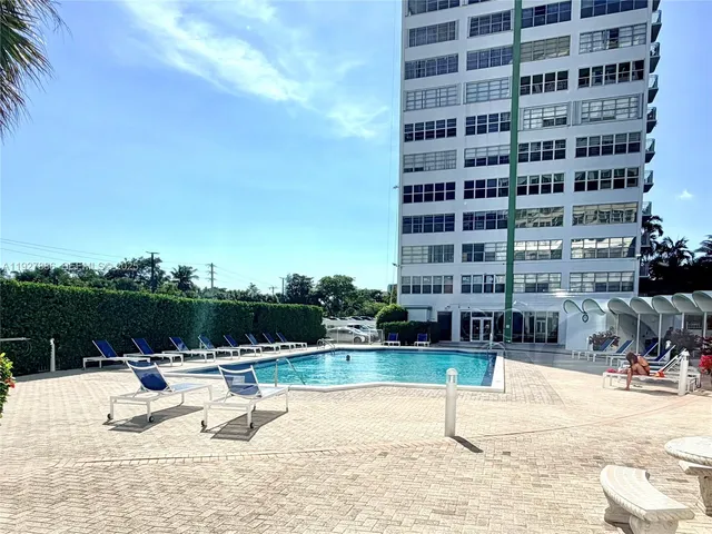 a view of a swimming pool with a lounge chair