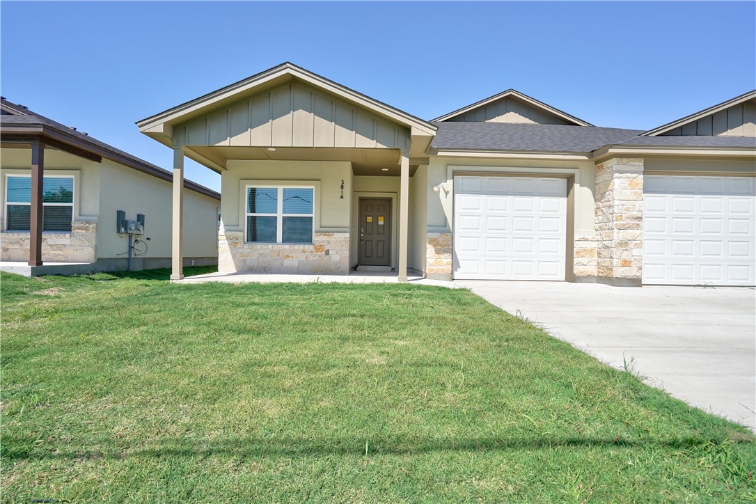 a front view of a house with a yard and porch